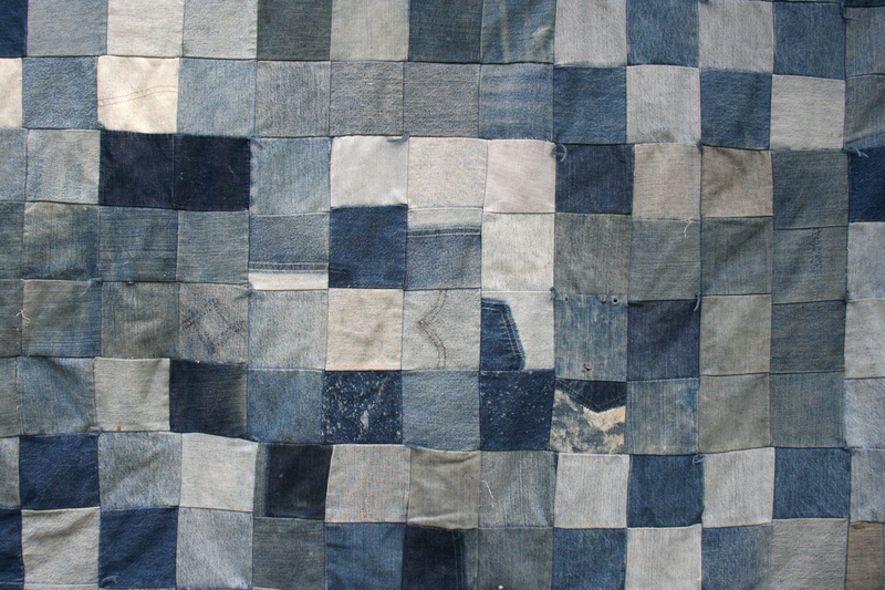 A large patchwork of denim fabric squares is arranged in a grid pattern, covering the entire image. The denim pieces vary in shades of blue, ranging from light to dark, with some showing signs of wear, fading,...
<br/>
<a class=